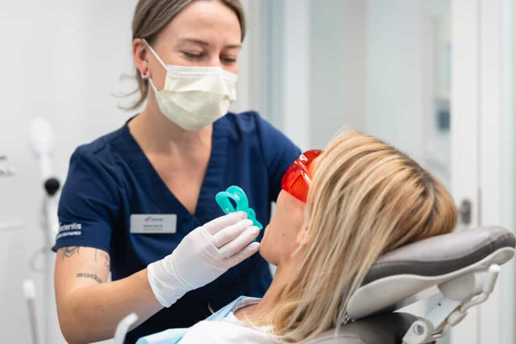 Dental hygienist advising a patient on teeth whitening treatment and best practices